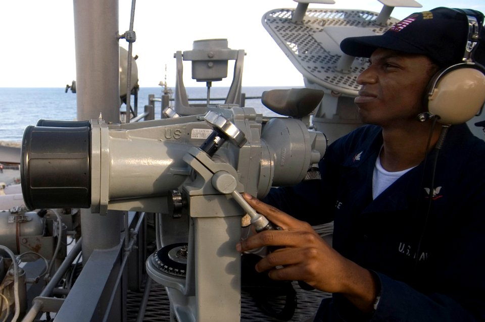 US Navy 070813-N-5387K-008 Operations Specialist 3rd Class Christopher uses high-powered binoculars on forward lookout watch aboard the USS Kitty Hawk (CV 63) signal bridge during exercise Valiant Shield 2007