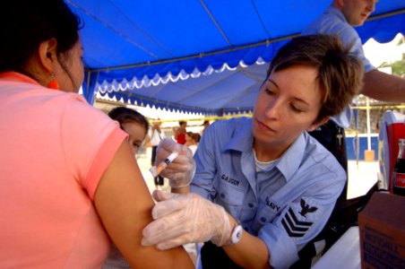 US Navy 070817-N-0194K-017 Hospital Corpsman 1st Class Seana Gauger, attached to Military Sealift Command hospital ship USNS Comfort (T-AH 20), gives a patient an immunization shot at Angelica Flores School