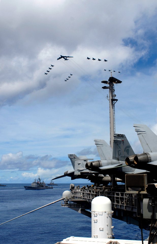 US Navy 070814-N-8157C-233 Aircraft from the Navy, Marine Corps and Air Force including a B-52 bomber conducts a fly by of the John C. Stennis, Kitty Hawk and Nimitz Carrier Strike Groups during a photo exercise