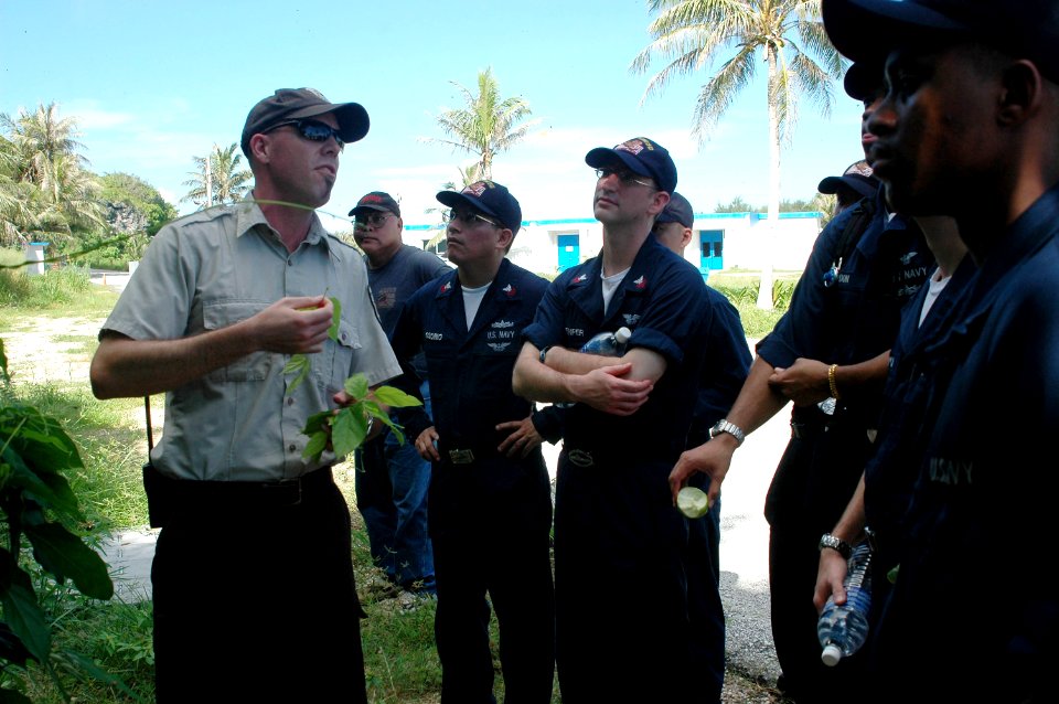 US Navy 070817-N-3946H-002 Matt Brown, deputy manager of the Guam National Wildlife Preserve, shows a sample of non-indigenous plant called Tangan-tangan to USS Kitty Hawk (CV 63) Sailors during a Guam National Wildlife Preserv