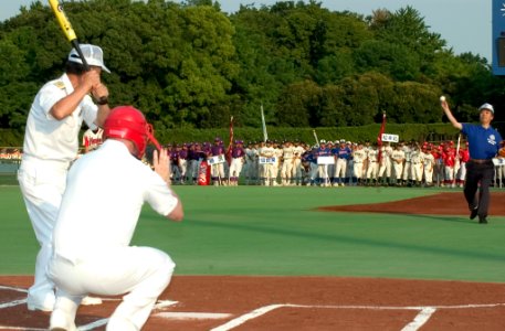 US Navy 070817-N-8534H-001 Ryoichi Kabaya, the Mayor of Yokosuka City, throws the opening pitch to Capt. Daniel Weed, commander of Fleet Activities Yokosuka, hoping to get one past Japan Maritime Self Defense Force Rear Adm. Is photo