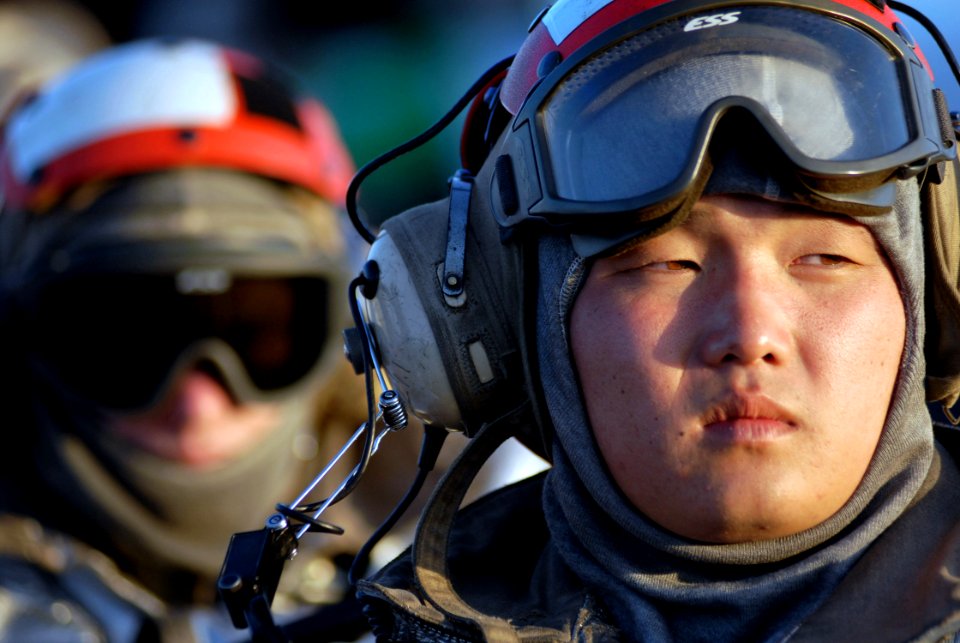 US Navy 070814-N-7981E-160 Aviation Boatswain's Mate (Handling) 3rd Class Woo Choe (right) and Aviation Boatswain's Mate 3rd Class Luke Bacon stand watch as part of a crash and salvage crew on the flight deck of the Nimitz-clas