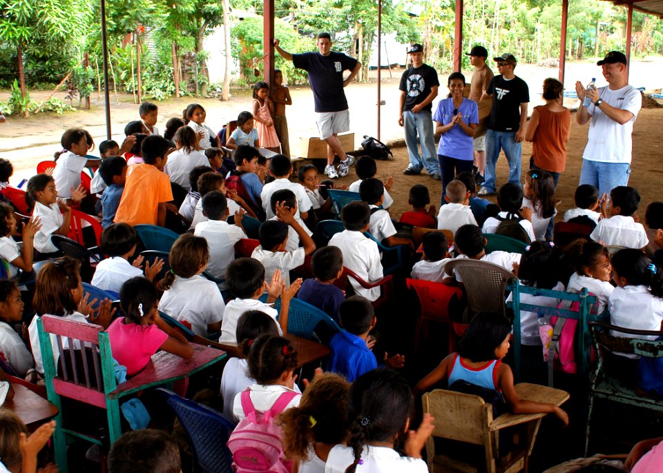 US Navy 070813-N-4021H-110 USS Pearl Harbor (LSD 52) Command Chaplain, Lt. Dennis Wheeler, and Sailors and Marines from the ship applaud after teaching students some basic English in a village outside of Cornito