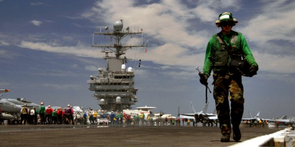 US Navy 070814-N-1229B-061 Aviation Boatswain's Mate (Equipment) Airman Joel Hernandez Jr. prepares the catapults for launching aircraft aboard Nimitz-class aircraft carrier USS Abraham Lincoln (CVN 72) photo