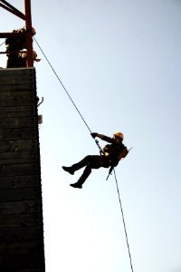 US Navy 070816-N-1328S-007 A Sailor attached to Mobile Security Squadron 3 rappels from the side of a cargo ship while conducting visit, board, search and seizure training during Seahawk 2007
