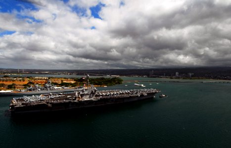 US Navy 070820-N-0684R-410 Sailors and Marines stand at attention while manning the rails as Nimitz-class aircraft carrier USS John C. Stennis (CVN 74) passes the USS Arizona Memorial