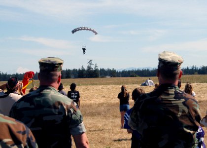 US Navy 070815-N-9860Y-038 A member of Explosive Ordnance Disposal Mobile Unit (EODMU) 11 completes a parachute landing to honor fallen comrades in Outlying Field photo