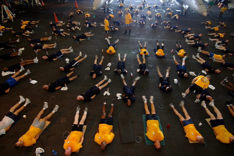 US Navy 070815-N-1598C-056 The chief petty officer's mess, along with chief petty officer selectees, conduct physical training in the hangar bay of nuclear-powered aircraft carrier USS Enterprise (CVN 65)