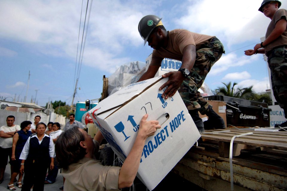 US Navy 070815-N-0194K-118 Cmdr. Lisa Ottenbacher and Steelworker 3rd Class Joel Washington, both attached to the Military Sealift Command hospital ship USNS Comfort (T-AH 20), unload medical equipment from a flatbed truck