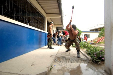 US Navy 070817-N-0194K-008 Builder 2nd Class Charles Page, a Seabee with Construction Battalion Maintenance Unit (CBMU) 202, breaks apart a section of a sidewalk at Angelica Flores School photo