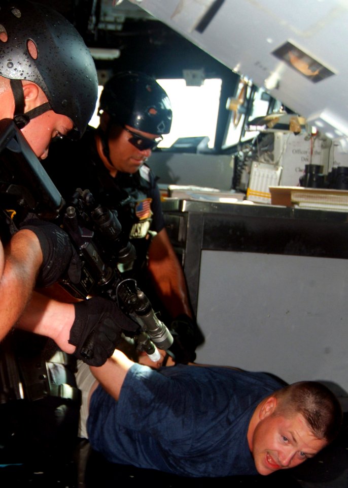 US Navy 070816-N-0120A-051 Cmdr. David L. Bossert, commanding officer of dock landing ship USS Harpers Ferry (LSD 49), is restrained by the visit, board, search and seizure (VBSS) team attached to the guided-missile frigate USS