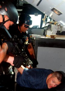 US Navy 070816-N-0120A-051 Cmdr. David L. Bossert, commanding officer of dock landing ship USS Harpers Ferry (LSD 49), is restrained by the visit, board, search and seizure (VBSS) team attached to the guided-missile frigate USS