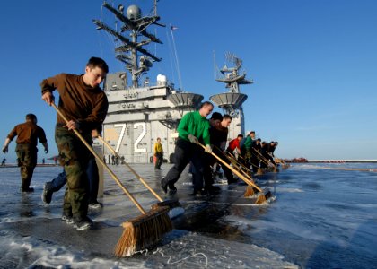 US Navy 070816-N-7981E-550 Personnel from air department and Carrier Air Wing (CVW) 2 scrub down the flight deck of Nimitz-class aircraft carrier USS Abraham Lincoln (CVN 72) after launching the last of CVW-2's aircraft photo