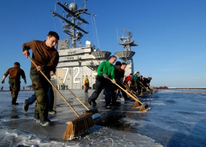 US Navy 070816-N-7981E-550 Personnel from air department and Carrier Air Wing (CVW) 2 scrub down the flight deck of Nimitz-class aircraft carrier USS Abraham Lincoln (CVN 72) after launching the last of CVW-2's aircraft
