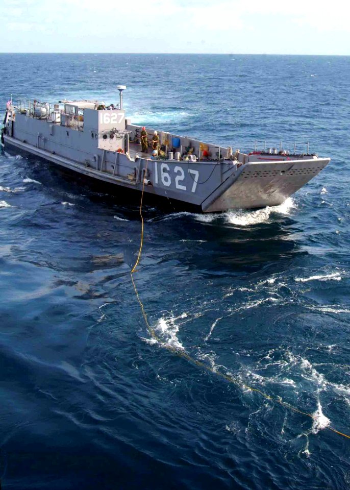 US Navy 070817-N-0120A-046 Landing Craft Utility (LCU) 1627 begins hauling in the messenger line from dock landing ship USS Harpers Ferry (LSD 49) to begin a towing exercise