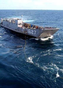 US Navy 070817-N-0120A-046 Landing Craft Utility (LCU) 1627 begins hauling in the messenger line from dock landing ship USS Harpers Ferry (LSD 49) to begin a towing exercise