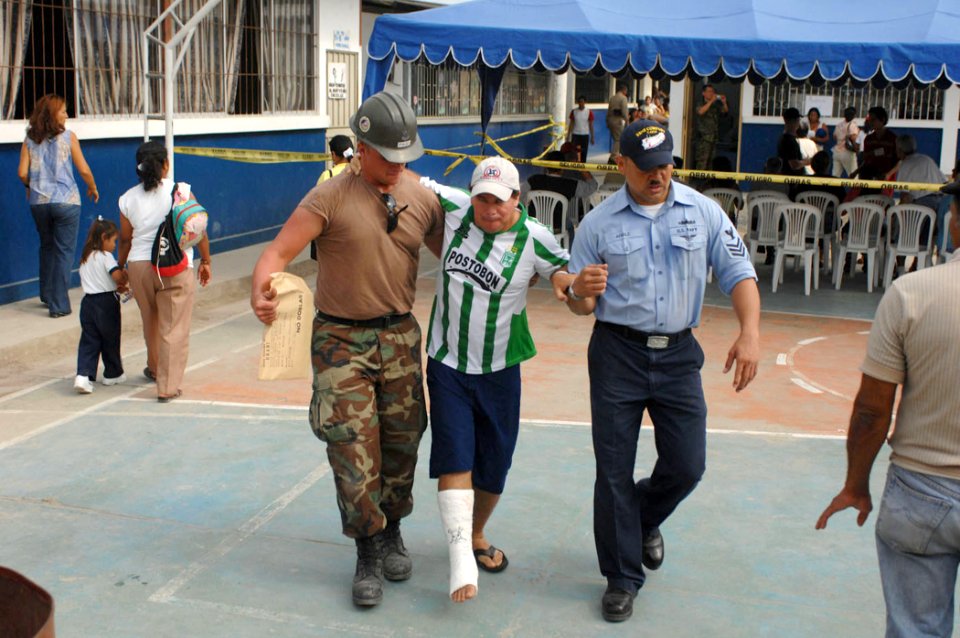 US Navy 070817-N-0194K-010 Builder 2nd Class Charles Page and Hospital Corpsman 1st Class Jose Afable, both attached to Military Sealift Command hospital ship USNS Comfort (T-AH 20), help a patient across the courtyard of Angel