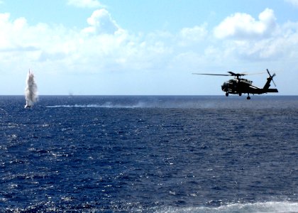 US Navy 070817-N-3038W-564 Explosive Ordnance Disposal Mobile Unit 11 Det. 11 Sailors in an HH-60H Seahawk neutralize a simulated mine photo