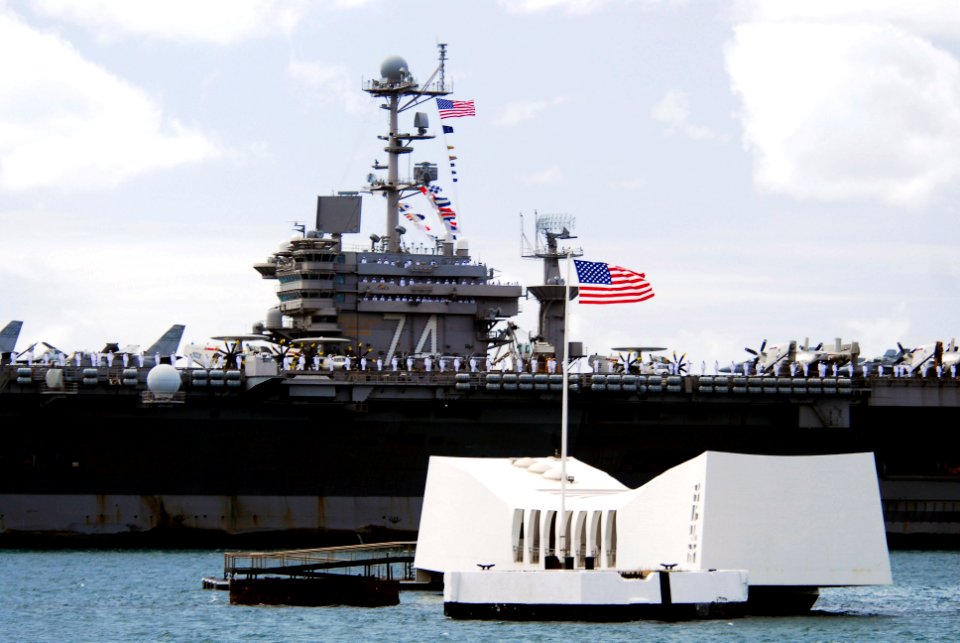 US Navy 070820-N-8157C-155 Nimitz-class aircraft carrier USS John C. Stennis (CVN 74) passes the USS Arizona Memorial in Pearl Harbor as she prepares to pick up family and friends for a Tiger Cruise