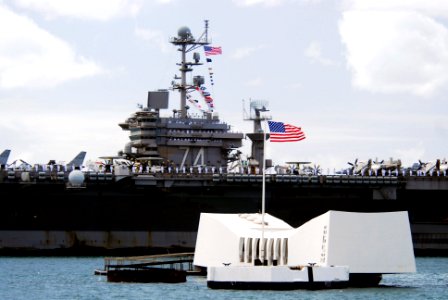 US Navy 070820-N-8157C-155 Nimitz-class aircraft carrier USS John C. Stennis (CVN 74) passes the USS Arizona Memorial in Pearl Harbor as she prepares to pick up family and friends for a Tiger Cruise