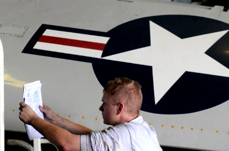 USS Carl Vinson sailor preps to remove plane wing 120204-N-RG587-009