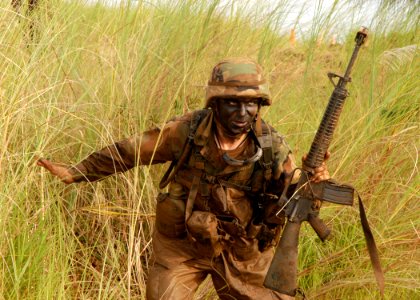 US Navy 070823-F-8678B-064 Construction Mechanic 3rd Class Greg A. Bottom tactically moves to a new fighting position during a field exercise with Naval Mobile Construction Battalion (NMCB) 4