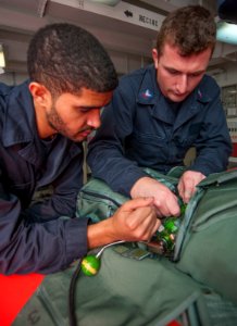 USS Carl Vinson Sailors conduct parachute maintenance 141111-N-TP834-024