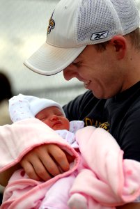US Navy 070820-N-7981E-039 Aviation Ordnanceman 3rd Class Donald Theriot meets his daughter for the first time on the pier after arriving home aboard Nimitz-class aircraft carrier USS Abraham Lincoln (CVN 72) photo