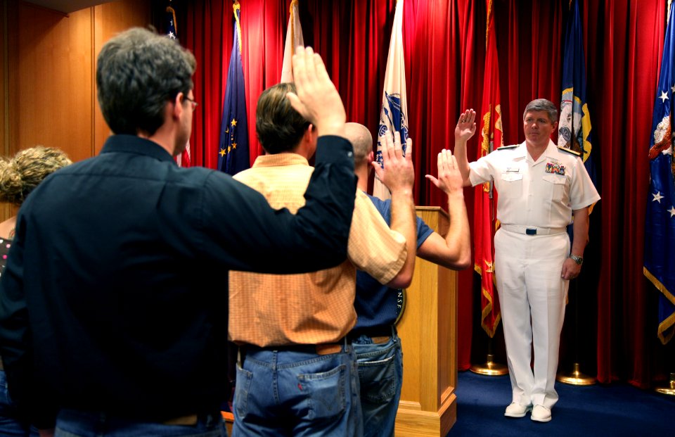 US Navy 070820-N-3271W-003 Rear Adm. Gerald R. Beaman, commander of Strike Force Training Pacific, conducts an oath of enlistment for six new recruits at the Military Entrance Processing Station