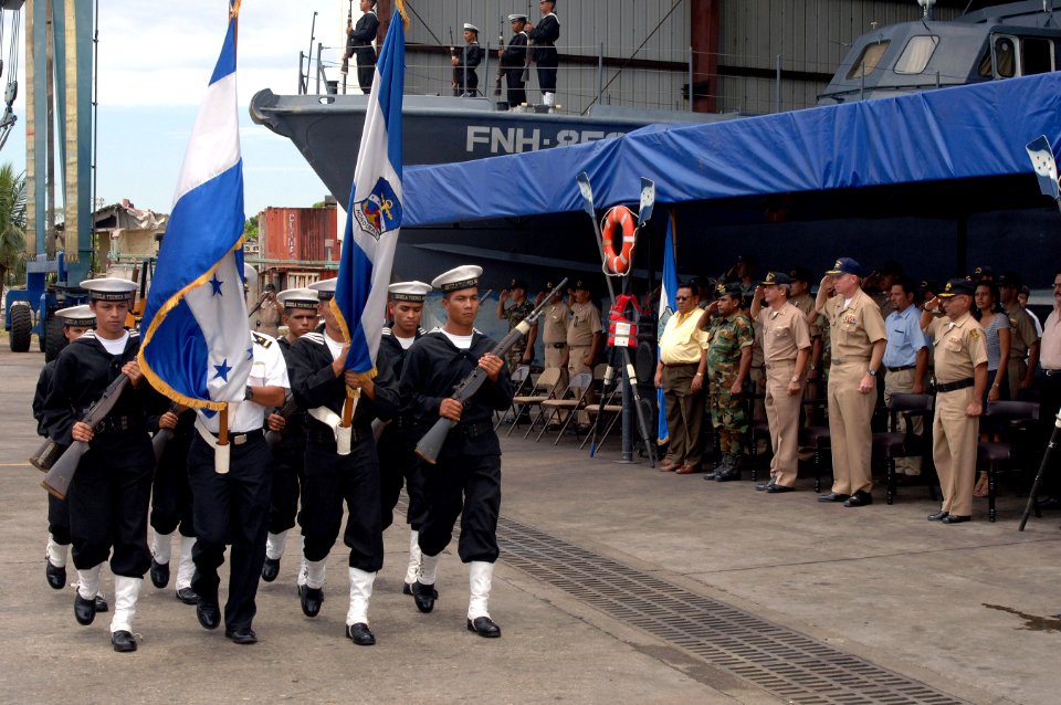 US Navy 070823-N-0989H-067 Capt. Douglas Wied, commander of Task Group 40.9, renders honors to a Honduran Navy color guard during a ceremony for the L.P. Guaynauras (FNH-1051)