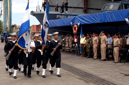 US Navy 070823-N-0989H-067 Capt. Douglas Wied, commander of Task Group 40.9, renders honors to a Honduran Navy color guard during a ceremony for the L.P. Guaynauras (FNH-1051) photo
