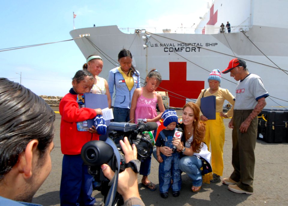 US Navy 070820-N-8704K-172 Valeska Saab, Miss Ecuador World, speaks to local media while accompanied by children with genetic skin disorders supported by the Miss Ecuador Foundation