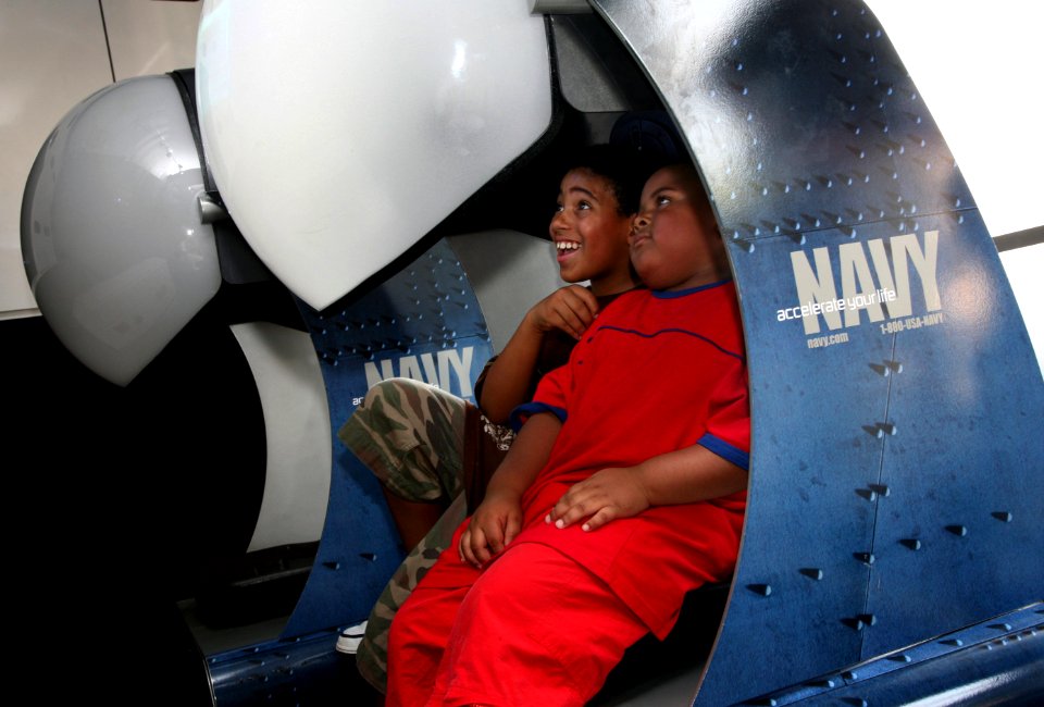 US Navy 070823-N-3271W-004 Two young brothers enjoy a spin in the Navy's Accelerate Your Life Experience that was on hand for a Back to School Bash at Julian Coleman Middle School