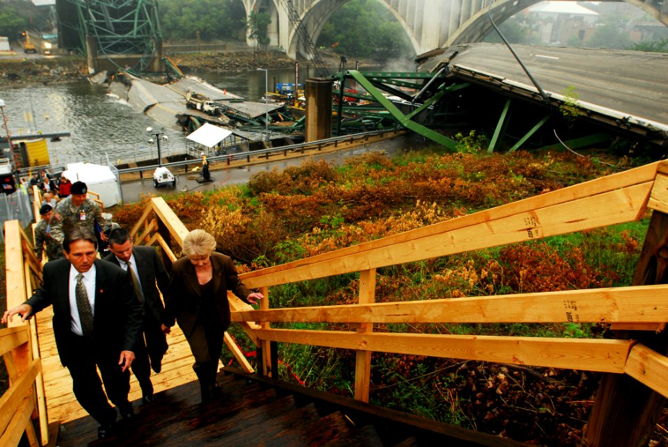 US Navy 070821-N-4515N-132 U.S. Transportation Secretary Mary E. Peters tours the site of the I-35 bridge collapse over the Mississippi River, with federal, state and local officials