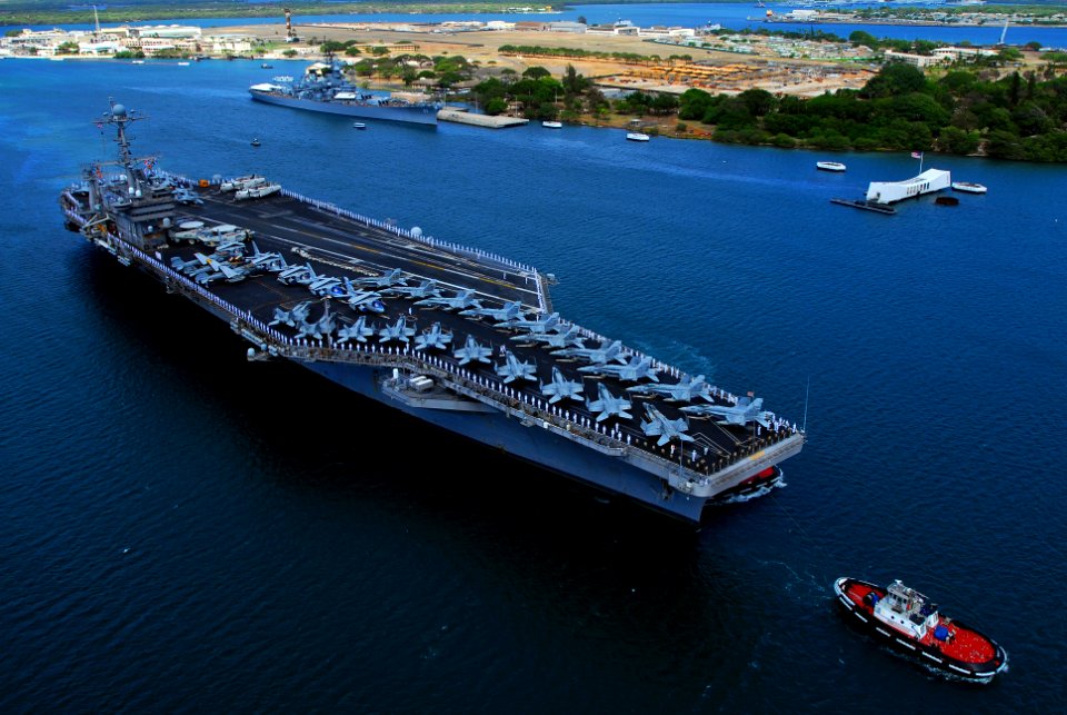 US Navy 070820-N-2659P-126 Sailors and Marines man the rails as Nimitz-class aircraft carrier USS John C. Stennis (CVN 74) passes the USS Arizona Memorial