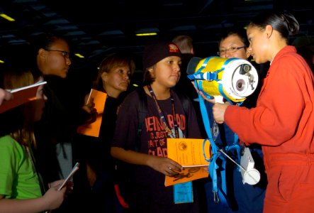 US Navy 070822-N-3038W-174 Damage Controlman 3rd Class Felicity Prestianni, right, from engineering department's damage control division, shows Tigers the safety equipment used aboard Nimitz-class aircraft carrier USS John C. S