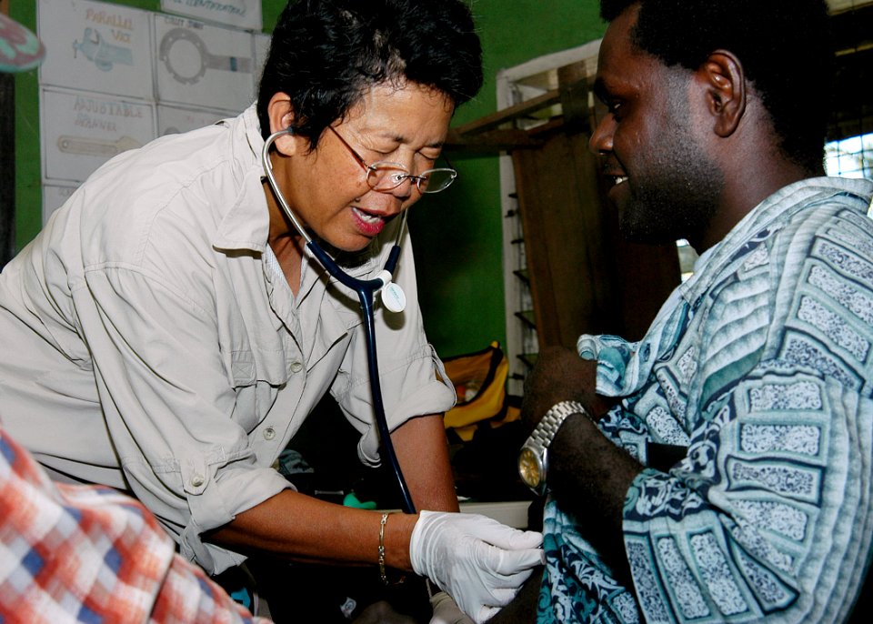 US Navy 070823-N-9195K-031 Project Hope volunteer Marilyn Pattillo listens to a local man's stomach during a medical civic action program at Voza Medical Clinic in support of Pacific Partnership