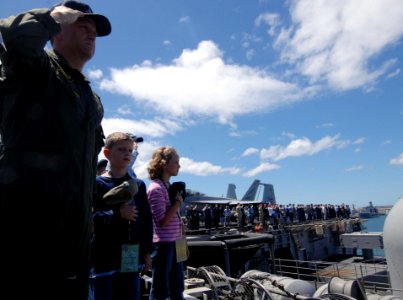 US Navy 070822-N-3729H-034 Capt. Sterling Gilliam, commander of Carrier Air Wing (CVW) 9, joins Sailors, family members and friends in honoring the USS Arizona Memorial as Nimitz-class aircraft carrier USS John C. Stennis (CVN