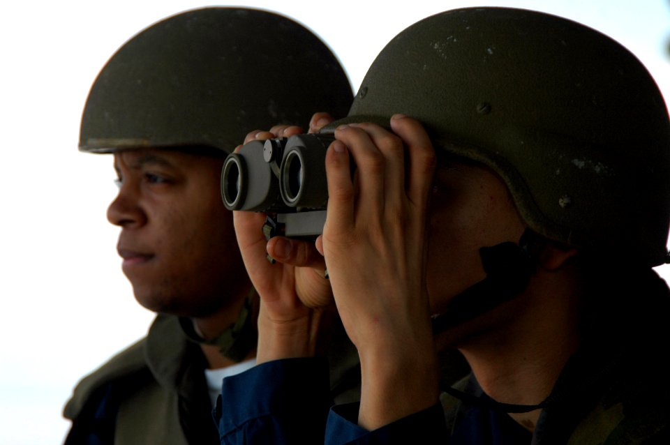 US Navy 070822-N-5387K-006 Aviation Ordnanceman Airman Isaac Reyes looks through binoculars while Aviation Ordnanceman Airman Derek Patterson scans the area around USS Kitty Hawk (CV 63)