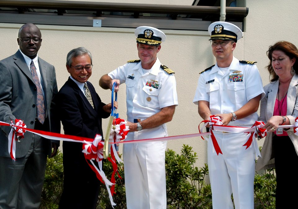 US Navy 070822-N-0807W-049 Capt. Tilghman D. Payne, commander of Fleet Activities Sasebo, and Mr. Tsuyoshi Oishi, Chief of Sasebo Defense Facilities Administration Office, cut the ceremonial ribbon at the grand opening of Fiddl