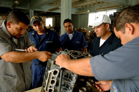 US Navy 070823-N-0989H-002 Machinery Technician 1st Class Joseph Hernandez and Machinery Technician 2nd Class Javier Carpio, from the U.S. Coast Guard International Training Division, assists Honduran sailors and port authority