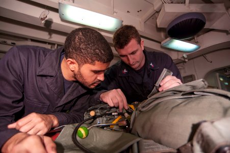 USS Carl Vinson Sailors conduct parachute maintenance 141111-N-TP834-006