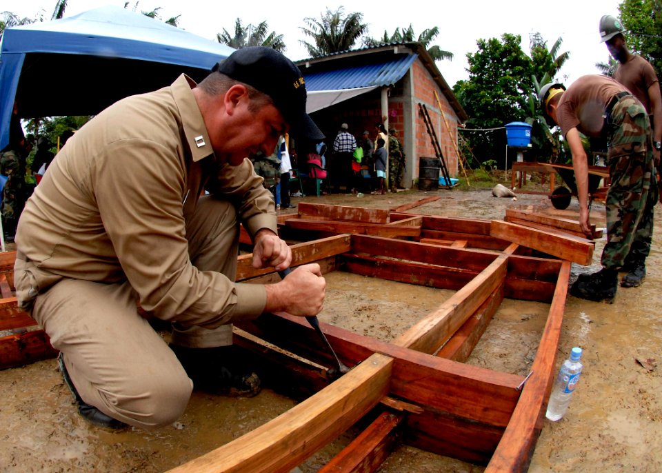 US Navy 070824-N-6278K-165 Lt. Jason Mangum, U.S. Public Health Service industrial hygienist attached to Military Sealift Command hospital ship USNS Comfort (T-AH 20), helps Seabees construct a medical clinic for local villager