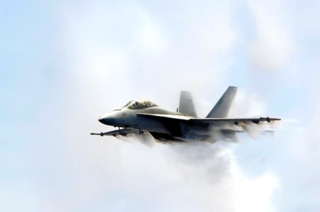 US Navy 070823-N-3136P-004 An F-A-18F Super Hornet, assigned to Strike Fighter Squadron (VFA) 102, punches through a cloud of water vapor while breaking the sound barrier