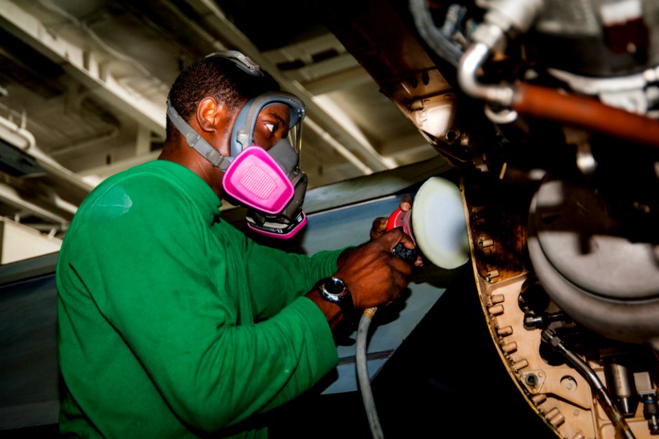 USS Carl Vinson Sailor sands an F-A-18F Super Hornet 141024-N-WD464-074