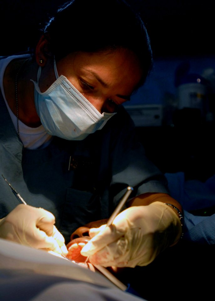 US Navy 070825-N-4238B-190 Columbian native Lt. j.g. Paula Gomez, of the U.S. Public Health Service attached to the Military Sealift Command hospital ship USNS Comfort (T-AH 20), cleans patient's teeth at the Buenaventura photo
