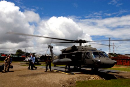 US Navy 070823-N-8704K-011 U.S. Navy Showband members attached to the Military Sealift Command hospital ship USNS Comfort (T-AH 20) offload instruments and musical equipment from a UH-60 Blackhawk attached to Joint Task Force B