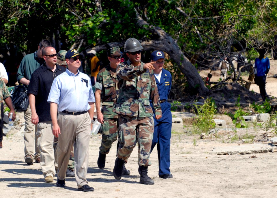 US Navy 070822-N-4267W-122 Secretary of the Navy (SECNAV) the Honorable Dr. Donald C. Winter walks with Builder 2nd Class Mike Carman as he describes the work Seabees with NMCB-7 and Amphibious Construction Battalion (ACB) 1 ar