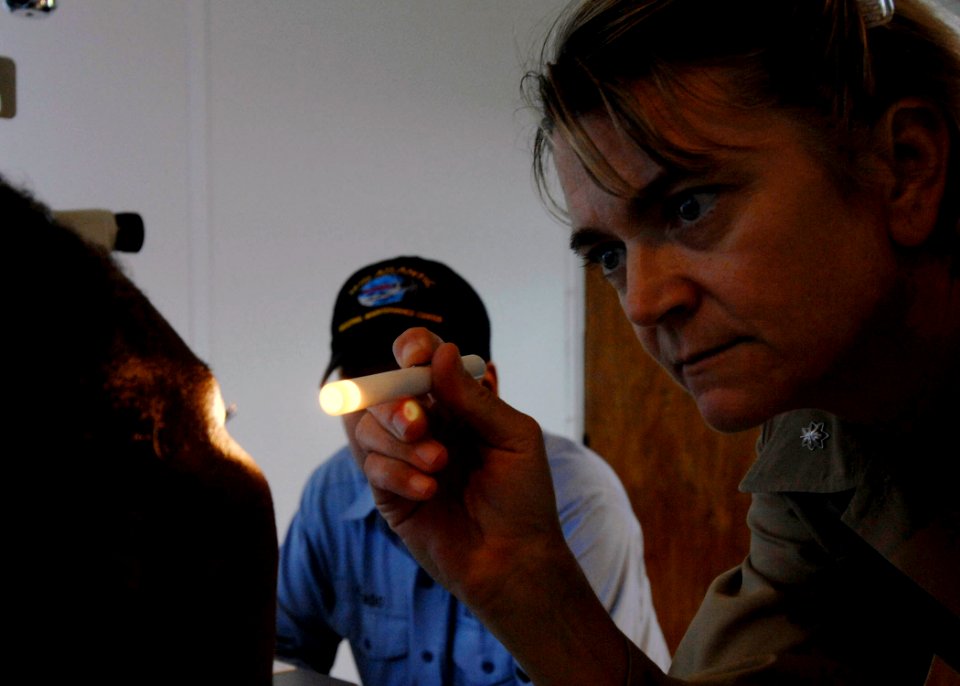 US Navy 070826-N-6278K-183 Cmdr. Anna Stalcup, an optometrist attached to the Military Sealift Command hospital ship USNS Comfort (T-AH 20), examines Susana Gamboa's eyes at Colombian Naval Hospital
