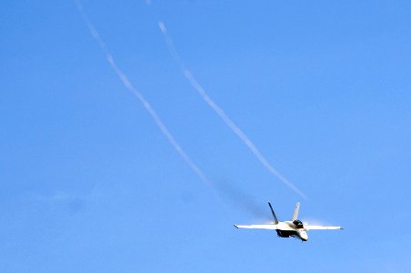 US Navy 070823-N-3136P-023 Water vapor flows over the wings of an F-A-18F Super Hornet, assigned to Strike Fighter Squadron (VFA) 102, as it performs a high-speed pass